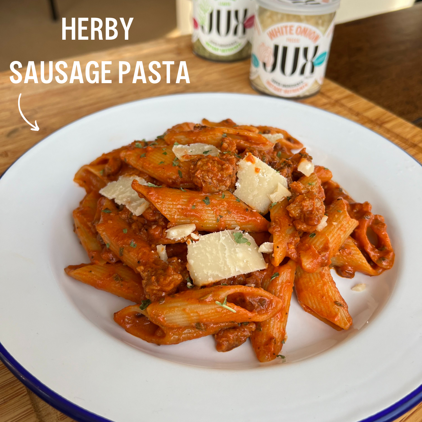 JUX Herby sausage pasta served on a plate next to JUX freeze-dried white onion