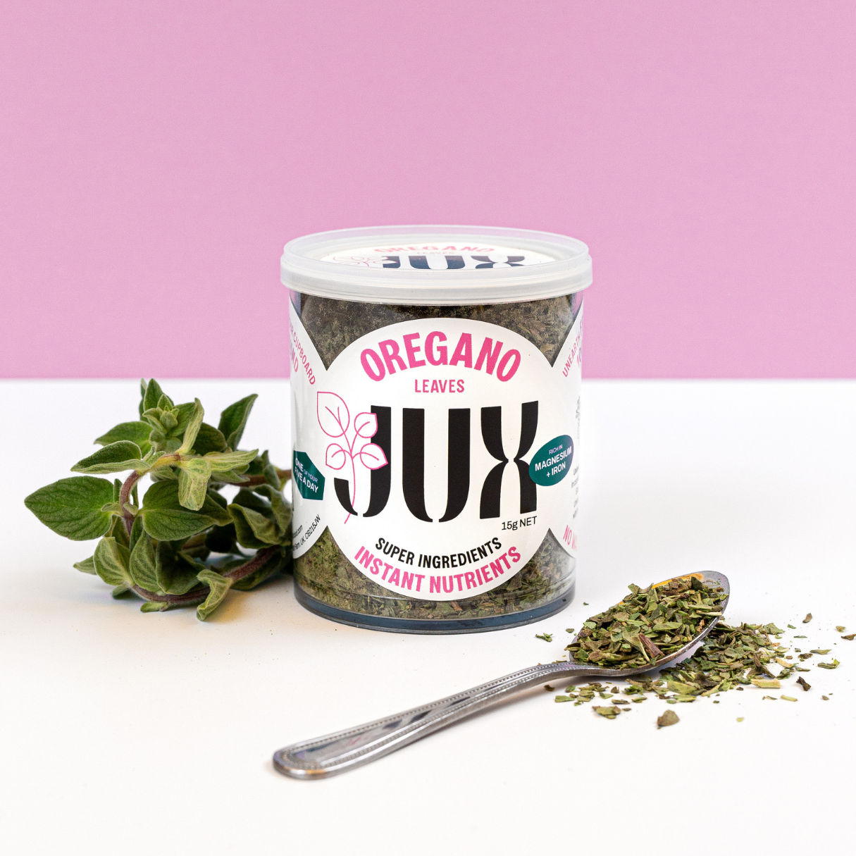 JUX Freeze-dried Oregano leaves on a teaspoon and in pot next to fresh oregano leaves