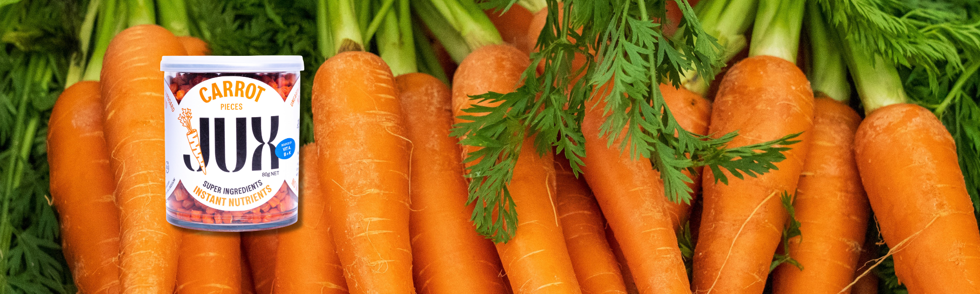 bunch of carrots with Jux carrot pieces jar on top