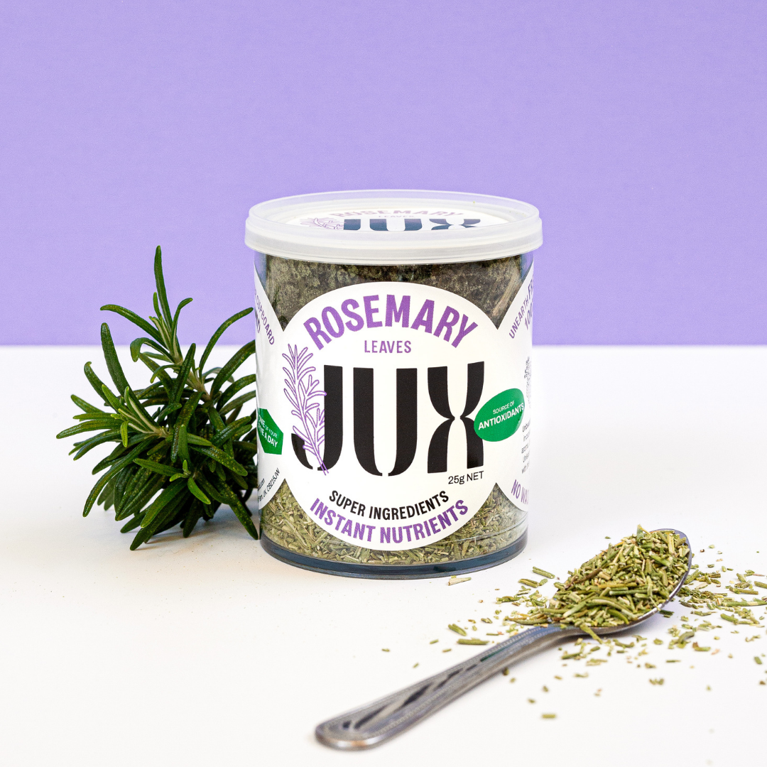Jar of JUX Freeze-dried Chopped Rosemary in pot and on teaspoon next to a fresh sprig of Rosemary