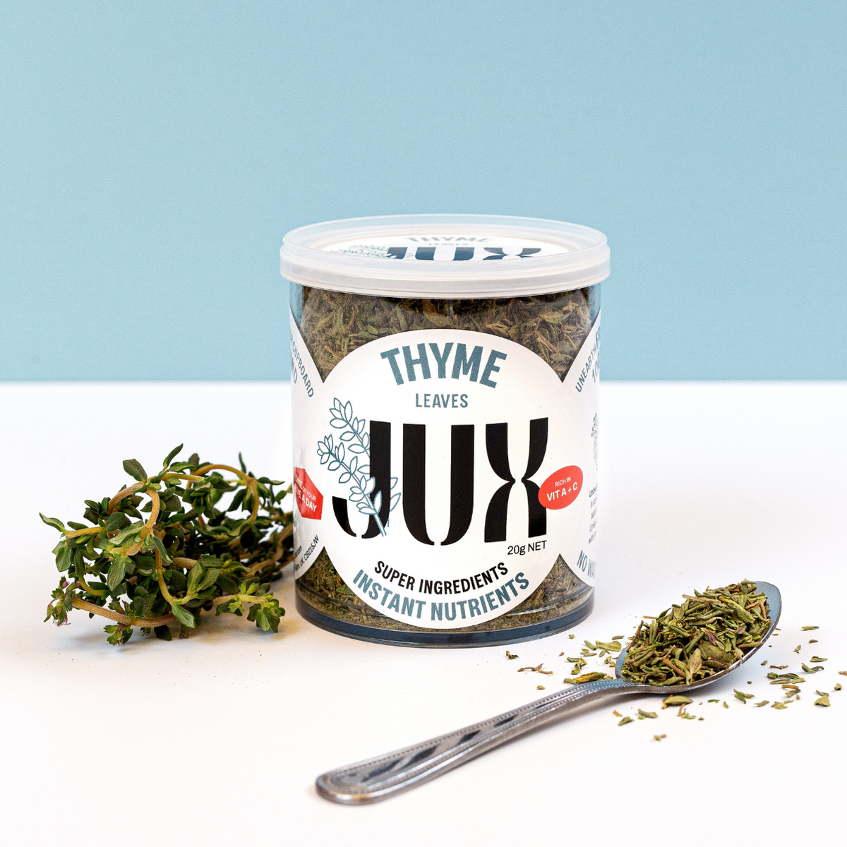 JUX chopped Freeze-dried Thyme in its pot and on a teaspoon next to fresh thyme