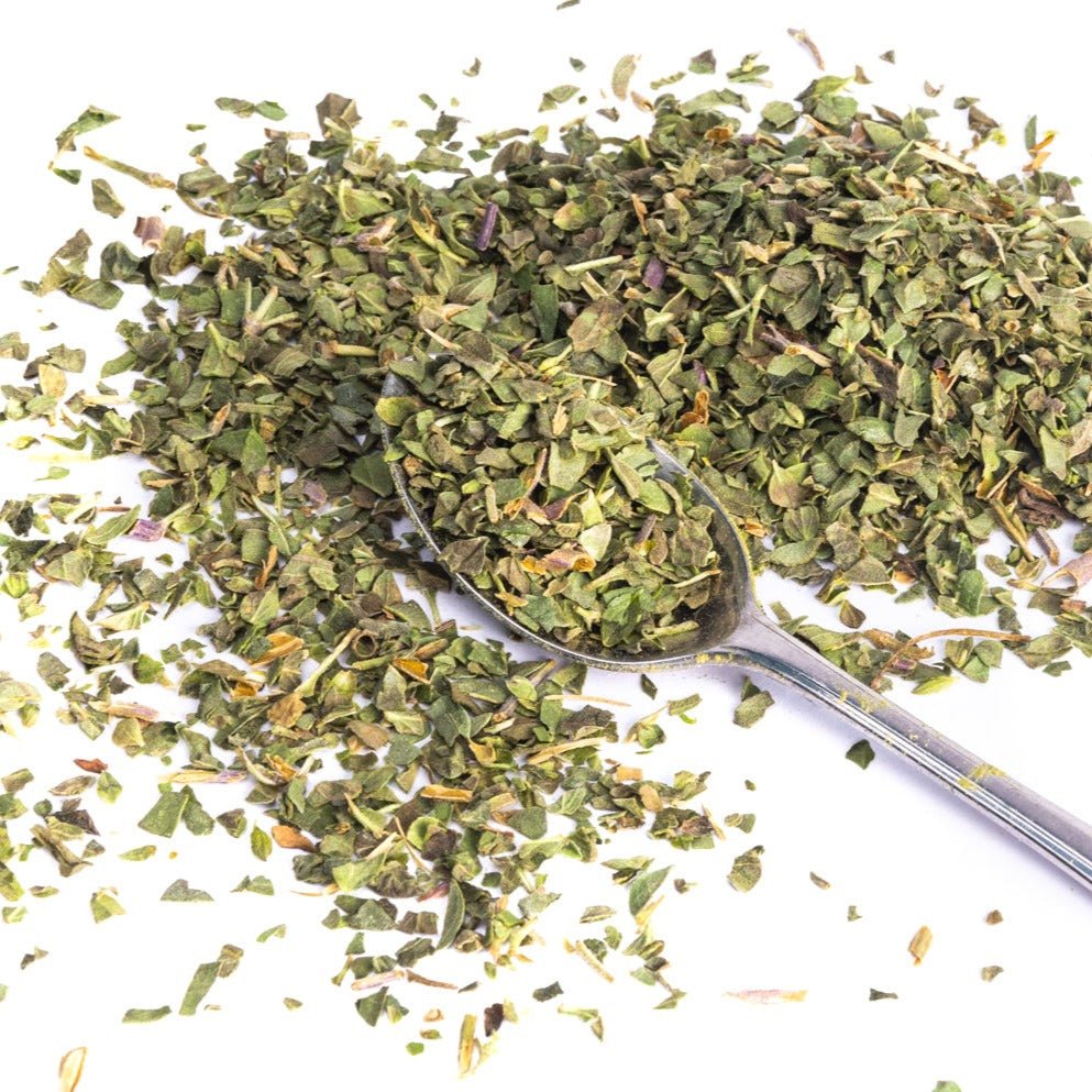 JUX freeze-dried chopped oregano leaves on a teaspoon